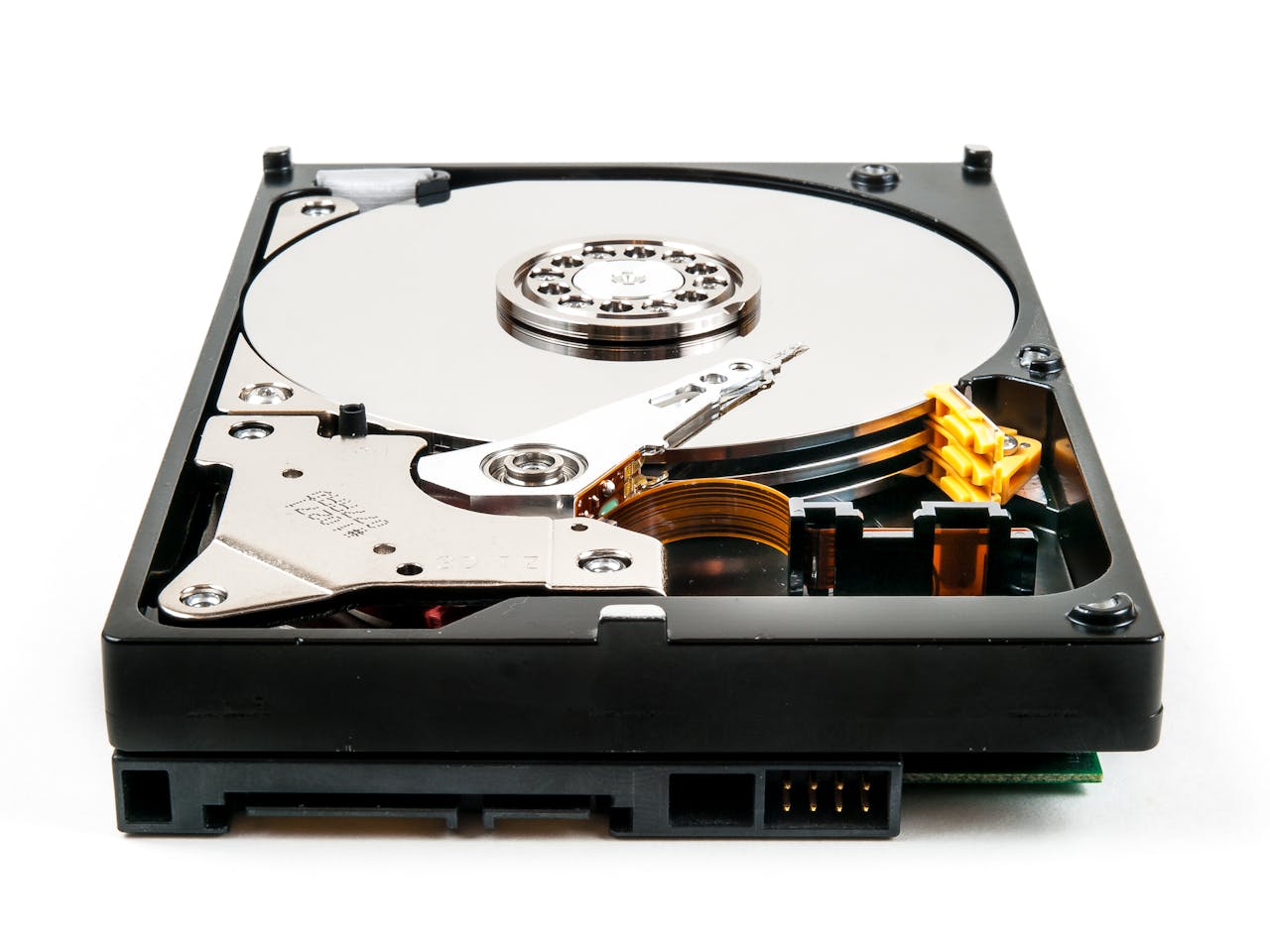 Detailed view of an open hard drive showcasing internal components against a white backdrop.